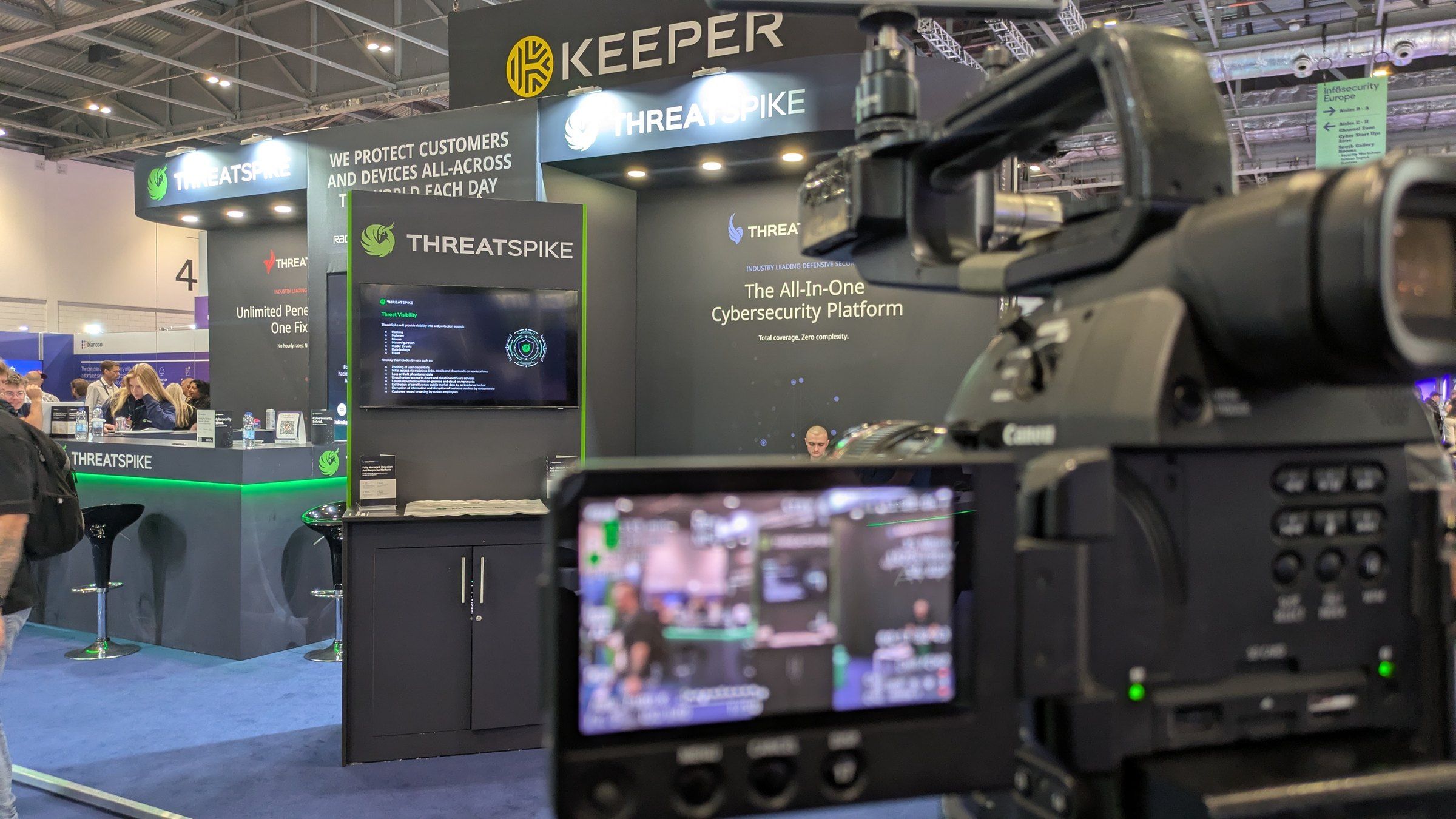 A Captive8 camera filming a cybersecurity company's exhibition stand